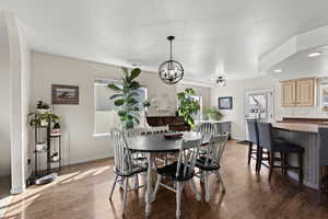 Dining area featuring light wood-style flooring and a chandelier