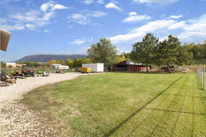 View of yard with a mountain view and an outbuilding
