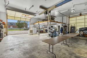 Garage featuring freestanding refrigerator and a workshop area