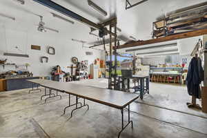 Dining area featuring concrete flooring and a workshop area