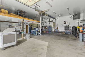 Garage with a workshop area and a heating unit