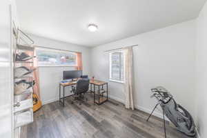 Office area with plenty of natural light and dark wood finished floors