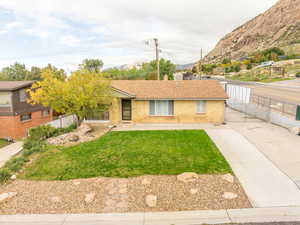Single story home with a shingled roof and brick siding
