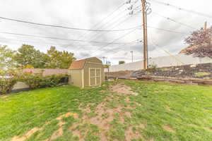 Fenced backyard with a storage shed