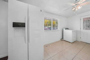 Washroom with washer / clothes dryer, light tile patterned floors, and a ceiling fan