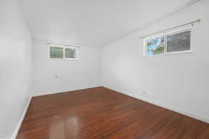 Unfurnished room with dark wood finished floors and baseboards