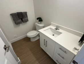 Bathroom featuring vanity and dark wood finished floors