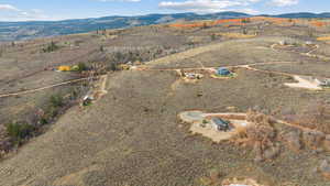 Aerial overview of property's location with rural landscape and a mountain backdrop