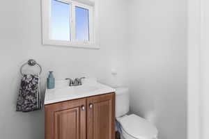 Bathroom with vanity and a textured wall