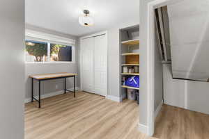 Bedroom with a closet and light wood-type flooring