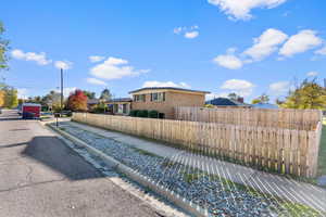 View of asphalt road with curbs and sidewalks