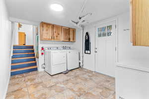 Washroom with cabinet space and washer and dryer