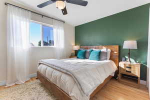 Bedroom with wood finished floors and a ceiling fan