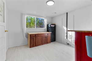 Office space with light wood-type flooring and baseboards