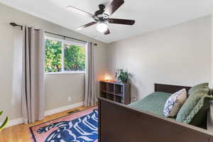 Bedroom with wood finished floors and ceiling fan