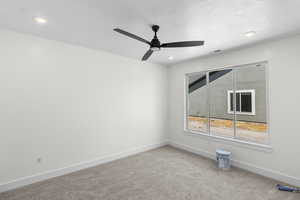 Spare room with carpet flooring, a ceiling fan, recessed lighting, and a textured ceiling
