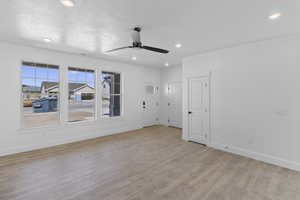 Empty room featuring recessed lighting, light wood-style flooring, and ceiling fan