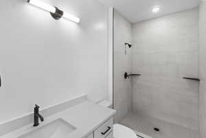 Bathroom with a stall shower and vanity