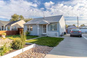 Bungalow-style home featuring roof with shingles and an outbuilding