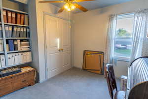 Carpeted office featuring baseboards and ceiling fan