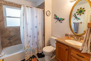 Full bath featuring vanity and shower / tub combo with curtain