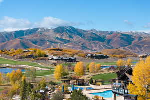 View of mountain background with a large body of water and a golf club