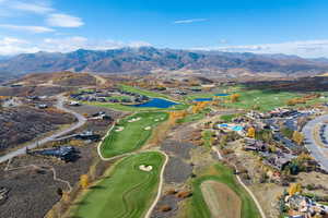 View of property location featuring a water and mountain view and a golf course