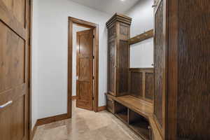 Mudroom with a barn door and baseboards