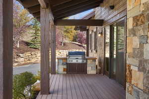 Wooden deck featuring exterior kitchen