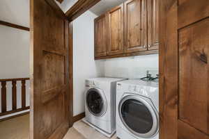 Washroom with cabinet space and separate washer and dryer
