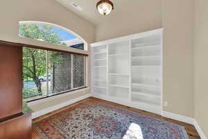 Spare room with baseboards and wood finished floors
