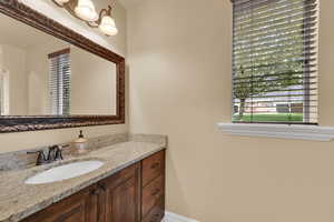 Bathroom featuring vanity and plenty of natural light