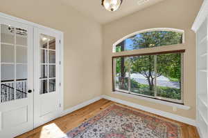 Foyer entrance featuring light wood-style flooring and baseboards