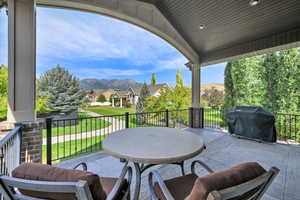 View of patio / terrace with a grill, a residential view, and a mountain view