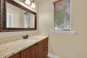 Bathroom with vanity and baseboards