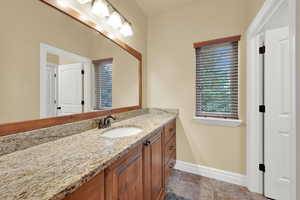 Bathroom featuring vanity and baseboards