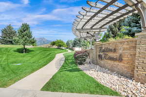 View of green lawn featuring a pergola and a mountain view