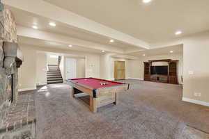 Playroom with recessed lighting, carpet flooring, beam ceiling, billiards table, and a large fireplace