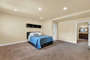 Bedroom featuring recessed lighting, carpet flooring, and connected bathroom
