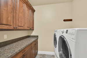 Laundry room featuring cabinet space and washing machine and dryer