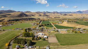 Aerial view of property's location with mountains and rural landscape