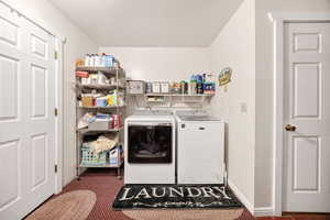 Laundry room with independent washer and dryer and a textured ceiling