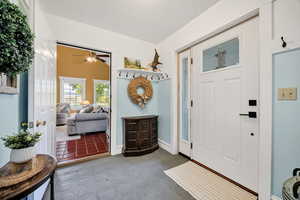 Foyer entrance featuring a ceiling fan and tile patterned floors