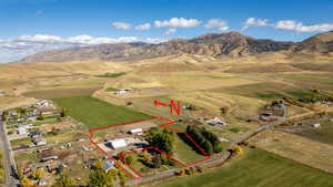 View of rural area featuring property parcel outlined, a mountainous background, and extensive farmland