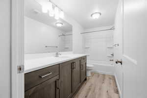 Bathroom featuring vanity, light wood-style flooring, and washtub / shower combination