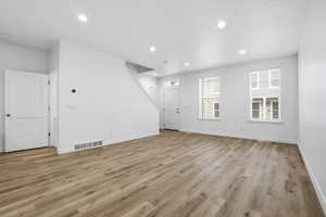 Unfurnished living room featuring recessed lighting and light wood-style flooring