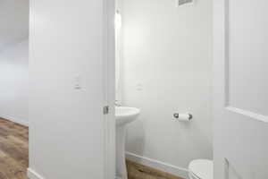 Half bathroom featuring baseboards and light wood finished floors