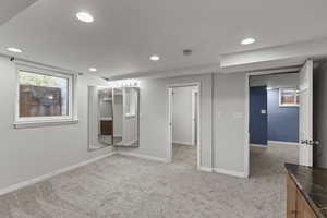 Unfurnished room with light colored carpet and recessed lighting