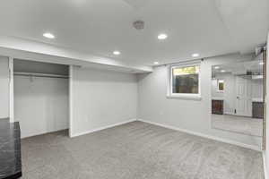 Basement with recessed lighting and light carpet