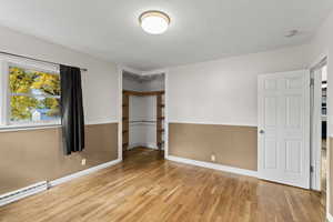 Unfurnished bedroom with a closet and light wood-type flooring